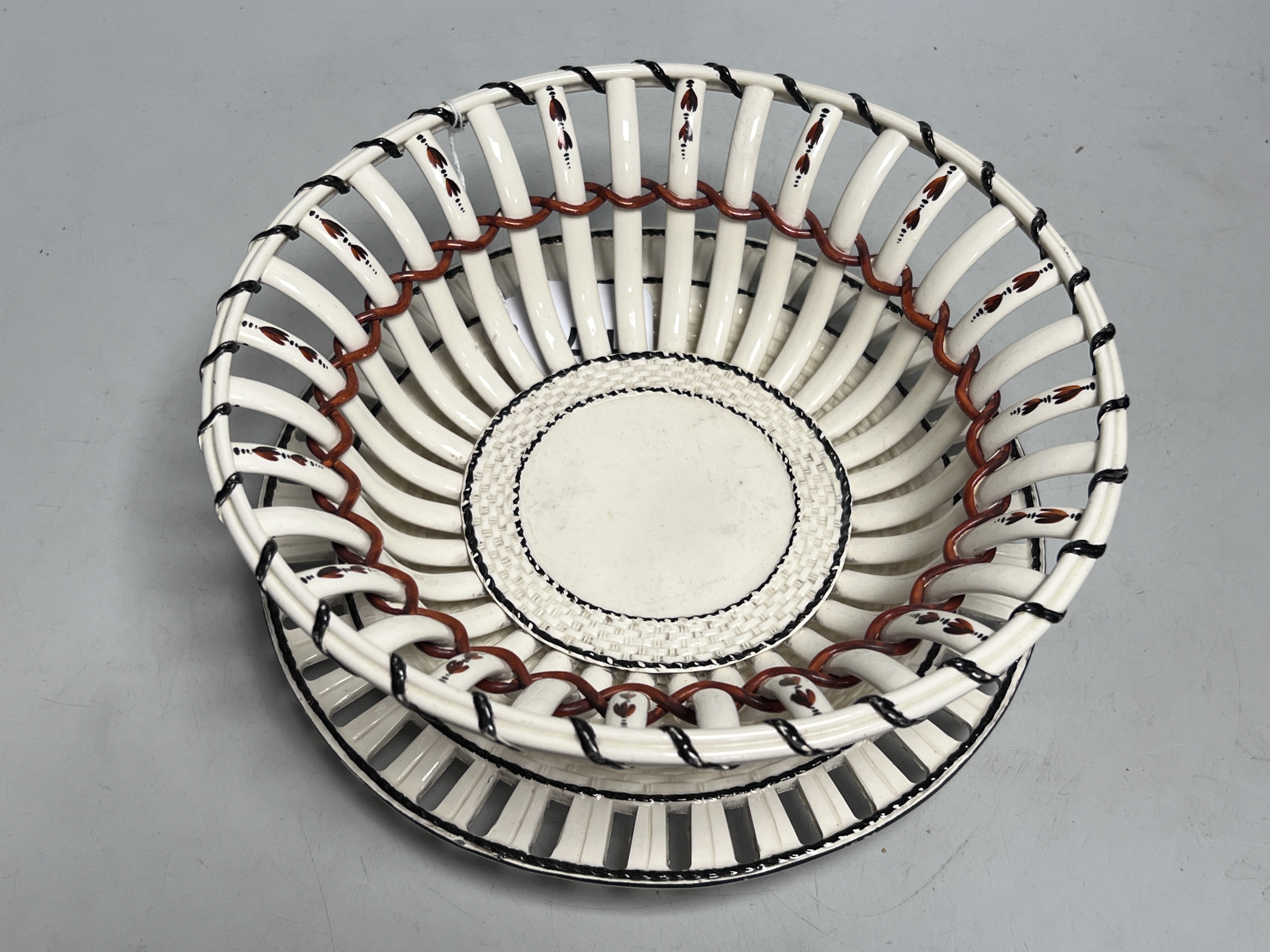 An early 19th century creamware chestnut basket and stand, 24cm